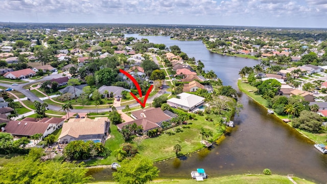 birds eye view of property with a residential view and a water view