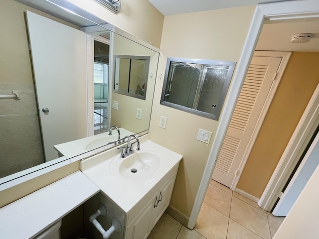 bathroom featuring tile patterned flooring, a shower, and vanity