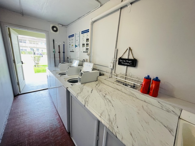 kitchen with light countertops, carpet, and independent washer and dryer