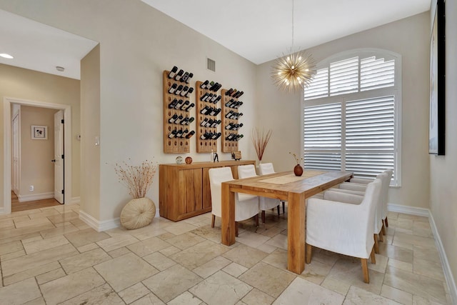 2465 Chesapeake Cir, West Palm Beach, FL 33409 - dining space featuring stone tile floors, baseboards, a notable chandelier, and visible vents