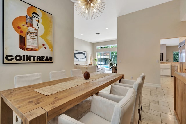 2465 Chesapeake Cir, West Palm Beach, FL 33409 - dining room featuring baseboards, stone tile floors, recessed lighting, and a notable chandelier