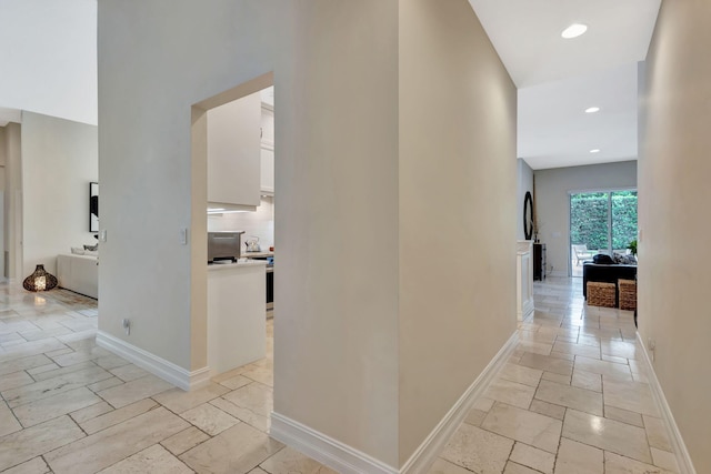 2465 Chesapeake Cir, West Palm Beach, FL 33409 - corridor featuring stone tile floors, recessed lighting, and baseboards