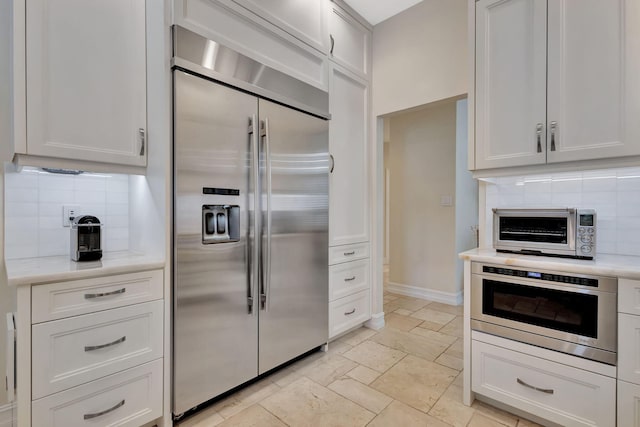 2465 Chesapeake Cir, West Palm Beach, FL 33409 - kitchen featuring a toaster, light countertops, backsplash, and stainless steel appliances