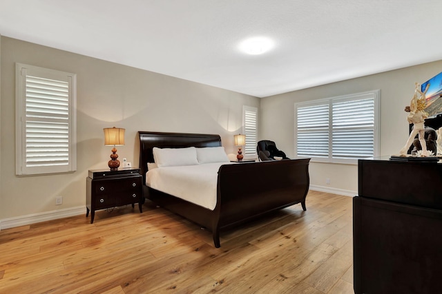 2465 Chesapeake Cir, West Palm Beach, FL 33409 - bedroom featuring baseboards and light wood-style floors