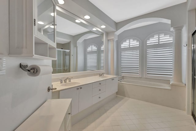 2465 Chesapeake Cir, West Palm Beach, FL 33409 - bathroom featuring a sink, tile patterned flooring, a stall shower, and ornate columns
