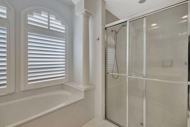2465 Chesapeake Cir, West Palm Beach, FL 33409 - full bath with a stall shower, ornate columns, and a garden tub