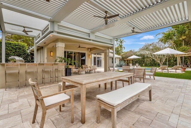 2465 Chesapeake Cir, West Palm Beach, FL 33409 - view of patio with outdoor dining area, a ceiling fan, grilling area, and a bar