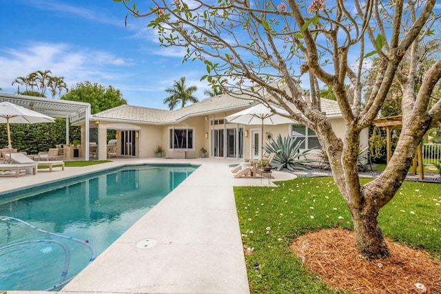 2465 Chesapeake Cir, West Palm Beach, FL 33409 - outdoor pool with a lawn and a patio