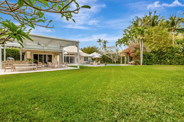 2465 Chesapeake Cir, West Palm Beach, FL 33409 - view of yard featuring a ceiling fan and a patio area