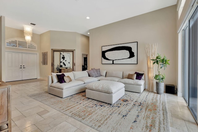 2465 Chesapeake Cir, West Palm Beach, FL 33409 - living room with recessed lighting, marble finish floor, a high ceiling, and a notable chandelier