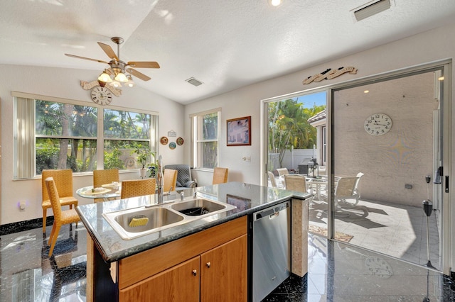 kitchen featuring a sink, granite finish floor, an island with sink, stainless steel dishwasher, and visible vents