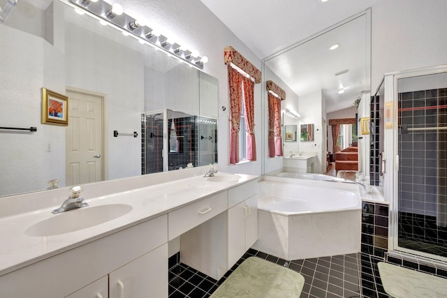 bathroom featuring double vanity, a shower stall, a sink, and a bath
