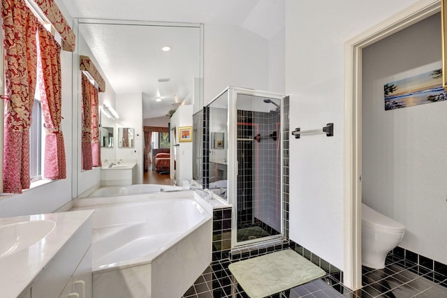 bathroom featuring vanity, a garden tub, toilet, tile patterned floors, and a stall shower