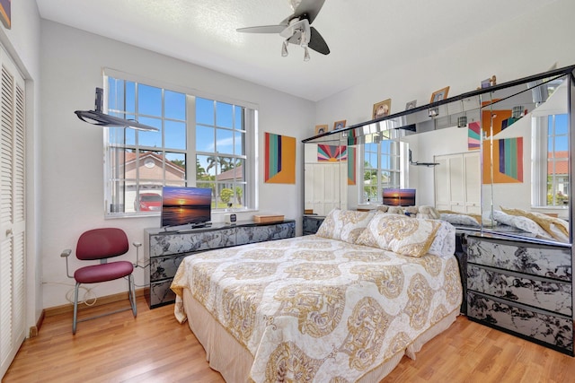 bedroom with baseboards, ceiling fan, and wood finished floors