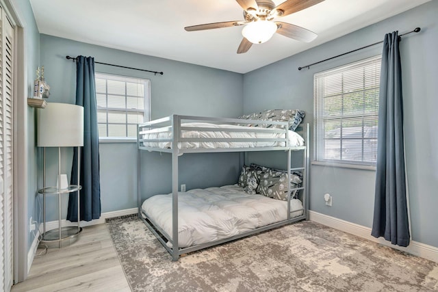 5810 Tucker Rd, Jupiter, FL 33458 - bedroom featuring baseboards, wood finished floors, and a ceiling fan