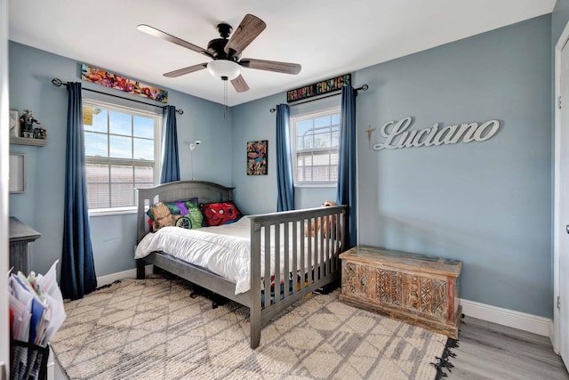 5810 Tucker Rd, Jupiter, FL 33458 - bedroom with baseboards, multiple windows, wood finished floors, and ceiling fan