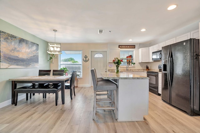 5810 Tucker Rd, Jupiter, FL 33458 - kitchen featuring black appliances, white cabinetry, baseboards, light wood-style floors, and recessed lighting