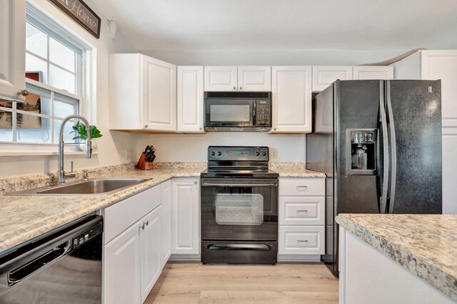 5810 Tucker Rd, Jupiter, FL 33458 - kitchen featuring black appliances, a sink, white cabinetry, and light countertops