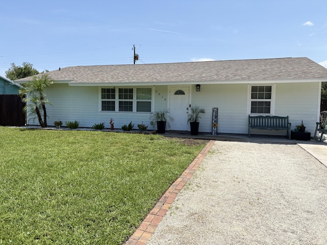 5810 Tucker Rd, Jupiter, FL 33458 - ranch-style home featuring a front yard, a porch, and roof with shingles