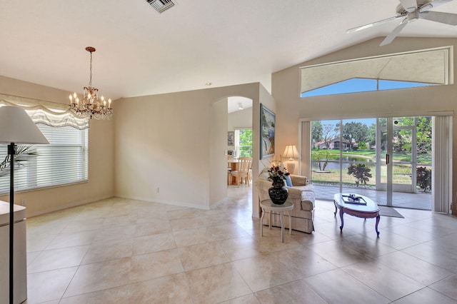 living area with visible vents, lofted ceiling, arched walkways, ceiling fan with notable chandelier, and light tile patterned floors