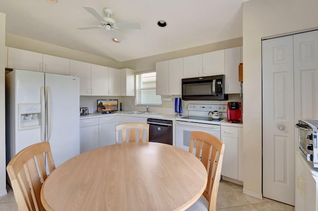 kitchen featuring a sink, white appliances, white cabinetry, a ceiling fan, and light tile patterned floors