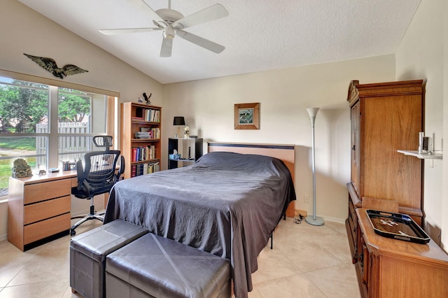 bedroom with light tile patterned floors, ceiling fan, a textured ceiling, and lofted ceiling