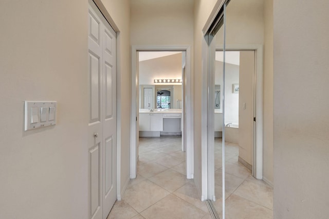 hallway with baseboards and light tile patterned floors