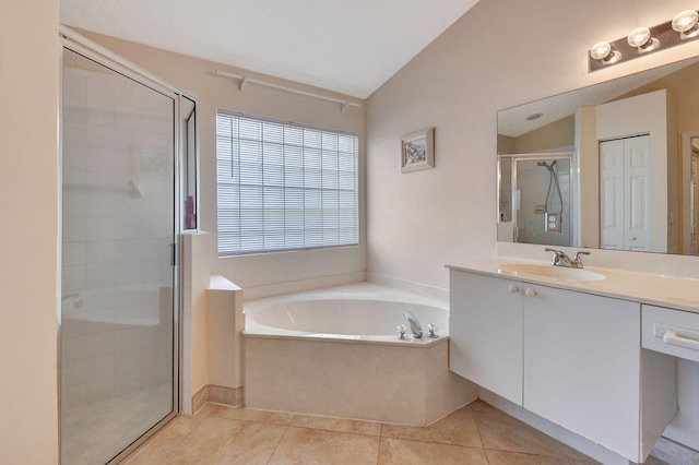 full bath featuring a bath, tile patterned flooring, a shower stall, vanity, and lofted ceiling