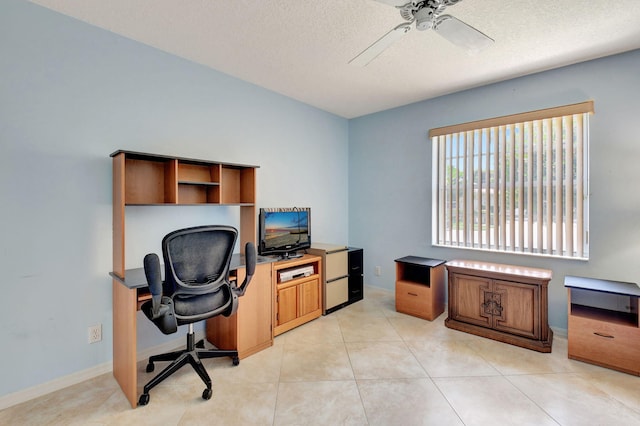 office featuring baseboards, a textured ceiling, and ceiling fan