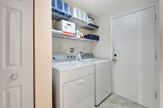 clothes washing area with light tile patterned floors, laundry area, and independent washer and dryer