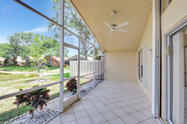 sunroom featuring ceiling fan