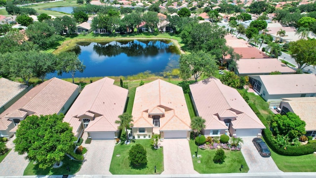 drone / aerial view with a residential view and a water view