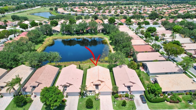drone / aerial view with a water view and a residential view
