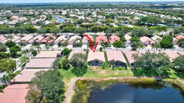 drone / aerial view featuring a water view and a residential view