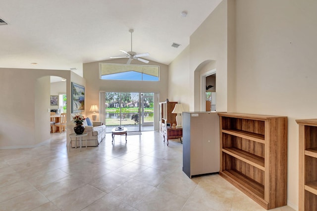 living room with arched walkways, ceiling fan, light tile patterned flooring, and visible vents