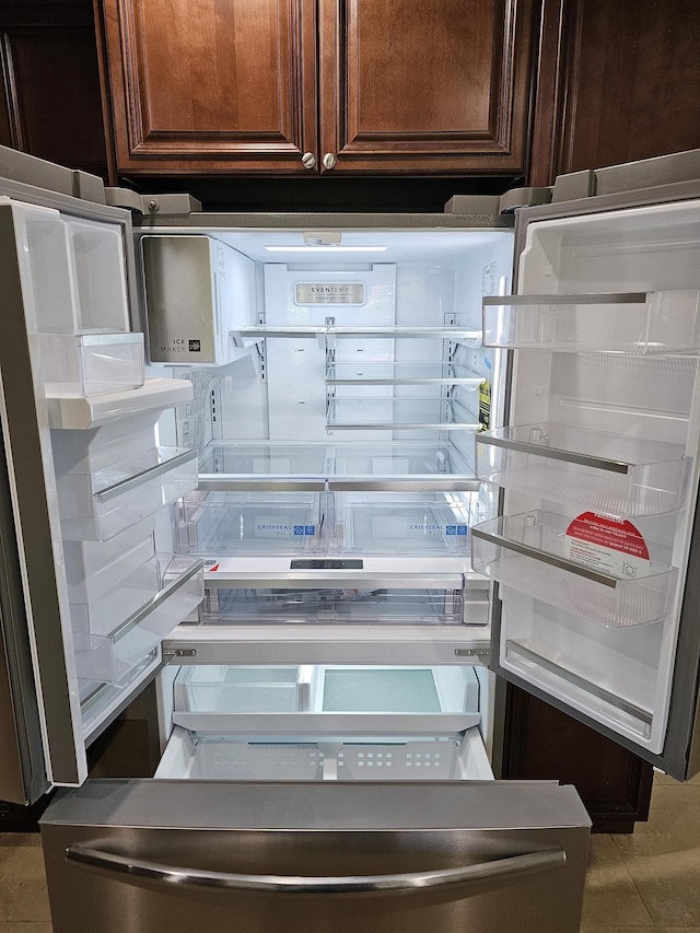 interior details with dark brown cabinets and fridge