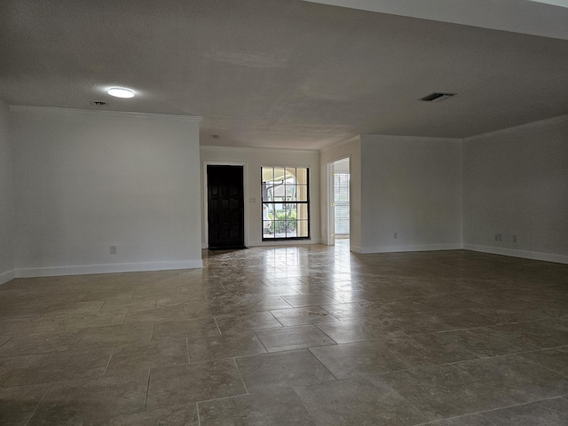 empty room with visible vents, crown molding, and baseboards