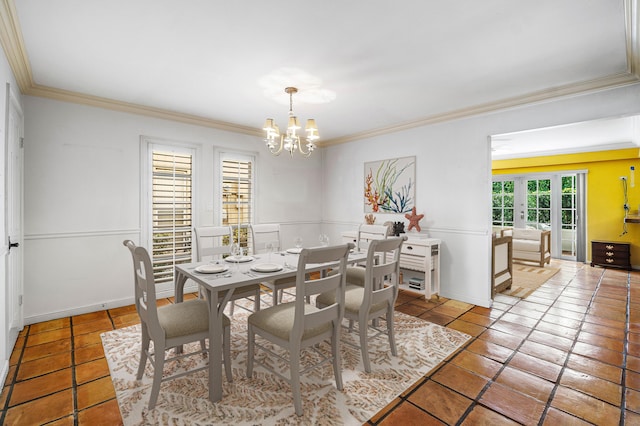 tiled dining area featuring baseboards, ornamental molding, a notable chandelier, and french doors
