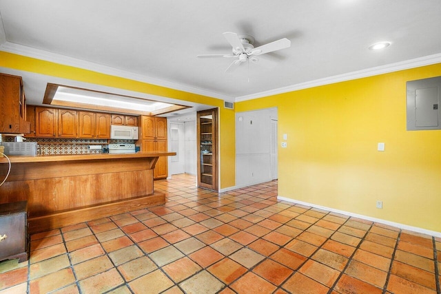 kitchen featuring white microwave, electric panel, baseboards, a ceiling fan, and a peninsula