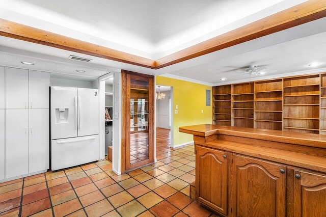 kitchen with recessed lighting, white refrigerator with ice dispenser, crown molding, visible vents, and baseboards
