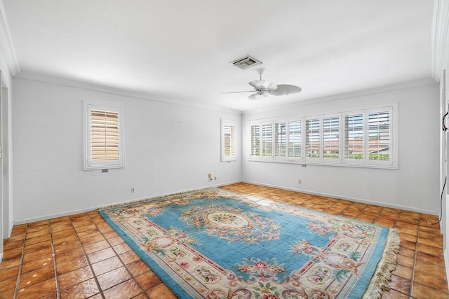 empty room with baseboards, visible vents, ornamental molding, and a ceiling fan