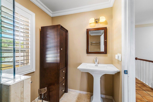 bathroom featuring tile patterned floors, baseboards, and crown molding