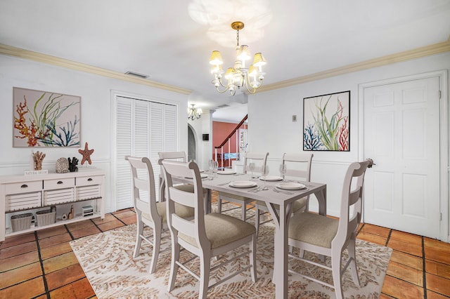 tiled dining space featuring crown molding, arched walkways, a notable chandelier, and visible vents
