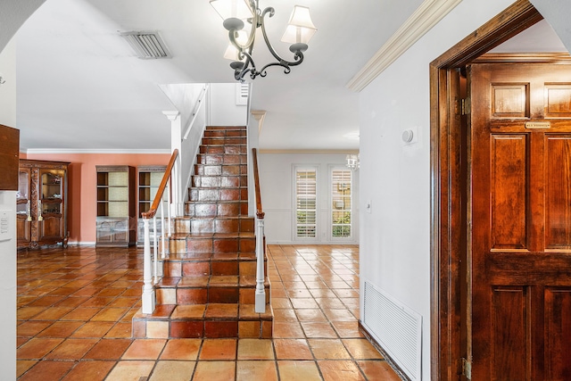 stairway with visible vents, crown molding, a chandelier, and baseboards