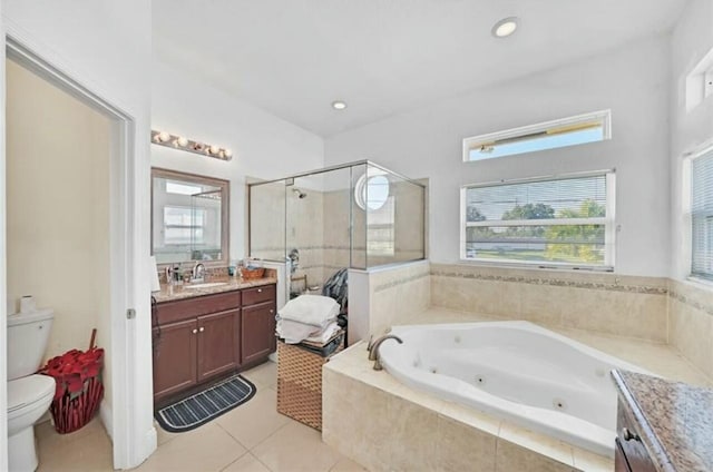 bathroom featuring a stall shower, toilet, a jetted tub, vanity, and tile patterned flooring