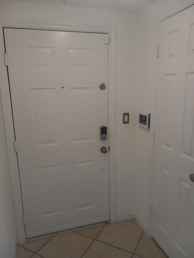 6450 Emerald Dunes Dr Unit 301, West Palm Beach, FL 33411 - doorway to outside featuring light tile patterned floors and baseboards