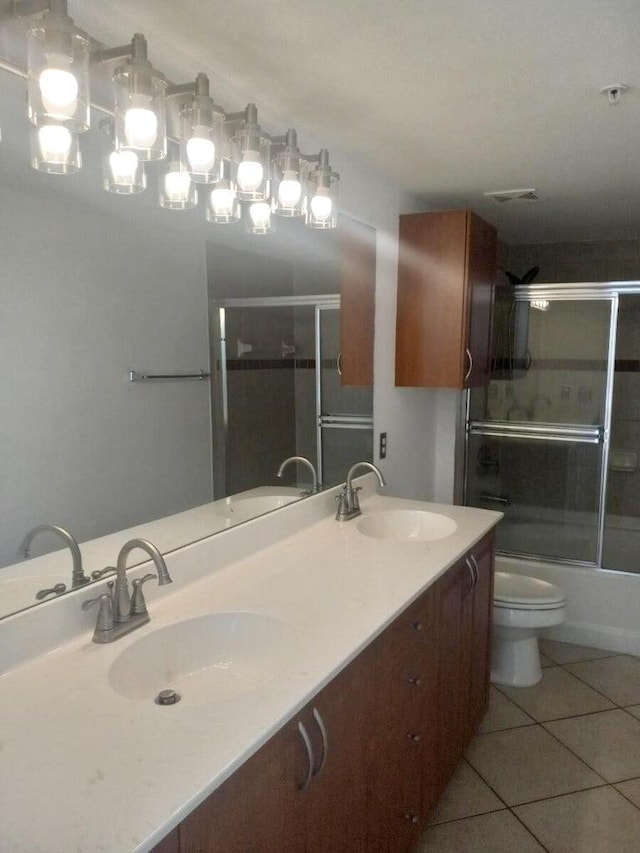 6450 Emerald Dunes Dr Unit 301, West Palm Beach, FL 33411 - full bath with tile patterned flooring, double vanity, toilet, and combined bath / shower with glass door