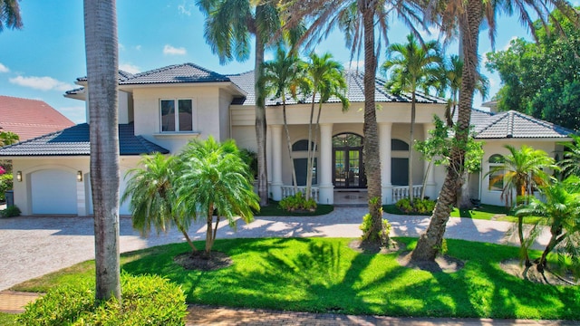 7090 Ayrshire Ln, Boca Raton, FL 33496 - mediterranean / spanish-style home with a tiled roof, a porch, stucco siding, driveway, and a front lawn