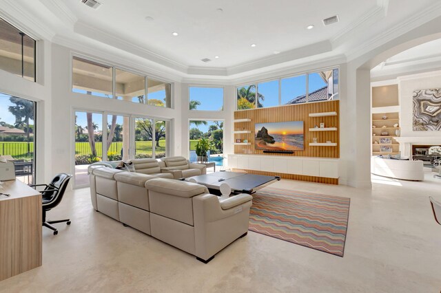7090 Ayrshire Ln, Boca Raton, FL 33496 - living room with ornamental molding, a high ceiling, arched walkways, a raised ceiling, and concrete flooring