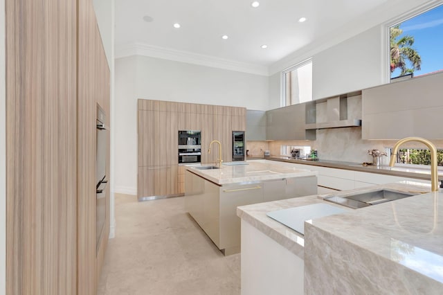 7090 Ayrshire Ln, Boca Raton, FL 33496 - kitchen with modern cabinets, a towering ceiling, wall chimney range hood, a center island with sink, and ornamental molding